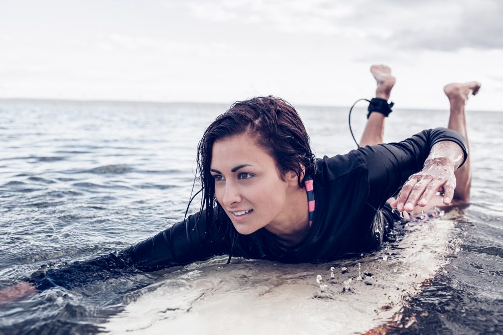 Paddling surfer lady